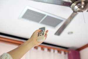 woman holding ceiling fan remote