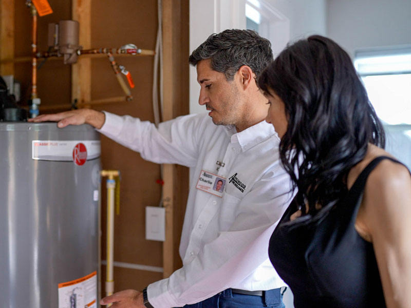 technician discussing water heater with client